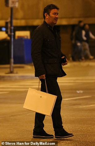After setting up his sleek new computer, he headed home holding his bag