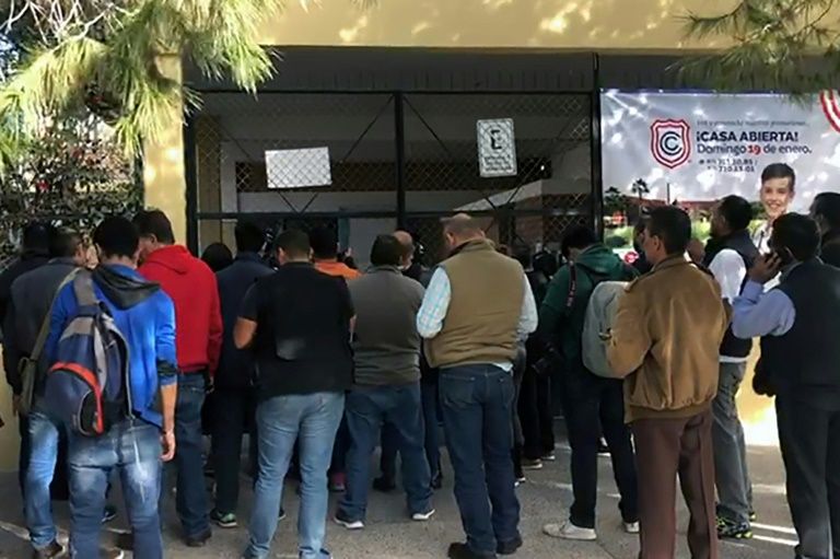 Relatives of schoolchildren gathered outside the elementary school in Mexico for news after a student shot and killed a teacher and wounded six others, and then apparently killed himself in Torreon (AFP Photo/STR)