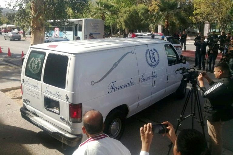 A funeral van leaves the Mexican school where a student shot and killed a teacher (AFP Photo/Brenda Alcala)