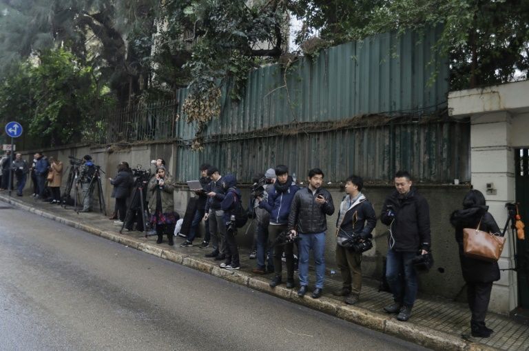 Journalists wait outside a Beirut house identified by court documents as belonging to Ghosn (AFP Photo/JOSEPH EID)