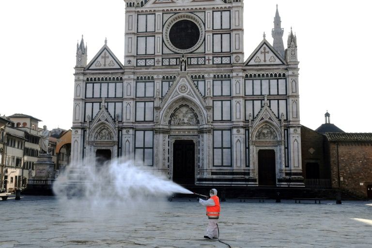 A municipal worker disinfects the Piazza Santa Croce in Florence as part of the measures taken by the Italian government to fight the spread of the COVID-19 (AFP Photo/Carlo BRESSAN)