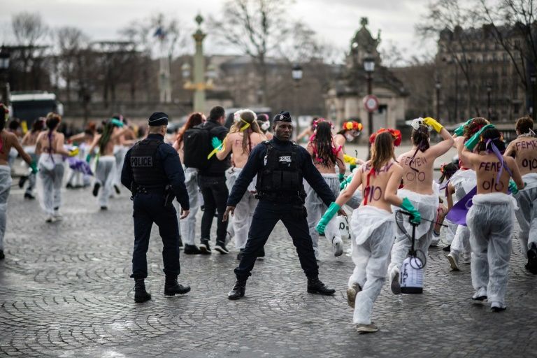 Topless Femen activists demonstrated at Place de la Concorde in Paris denouncing "the patriarchal pandemic" (AFP Photo/Martin BUREAU)