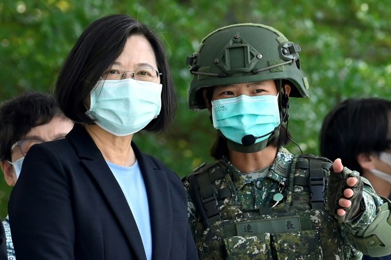 Taiwan President Tsai Ing-wen listens to a  soldier during a visit to a military base in Tainan on April 9
