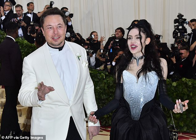 It comes after billionaire entrepreneur Musk, who recently had a baby with Grimes, cryptically tweeted 'Take the red pill' to his 34 million followers on Sunday evening (Couple pictured together)