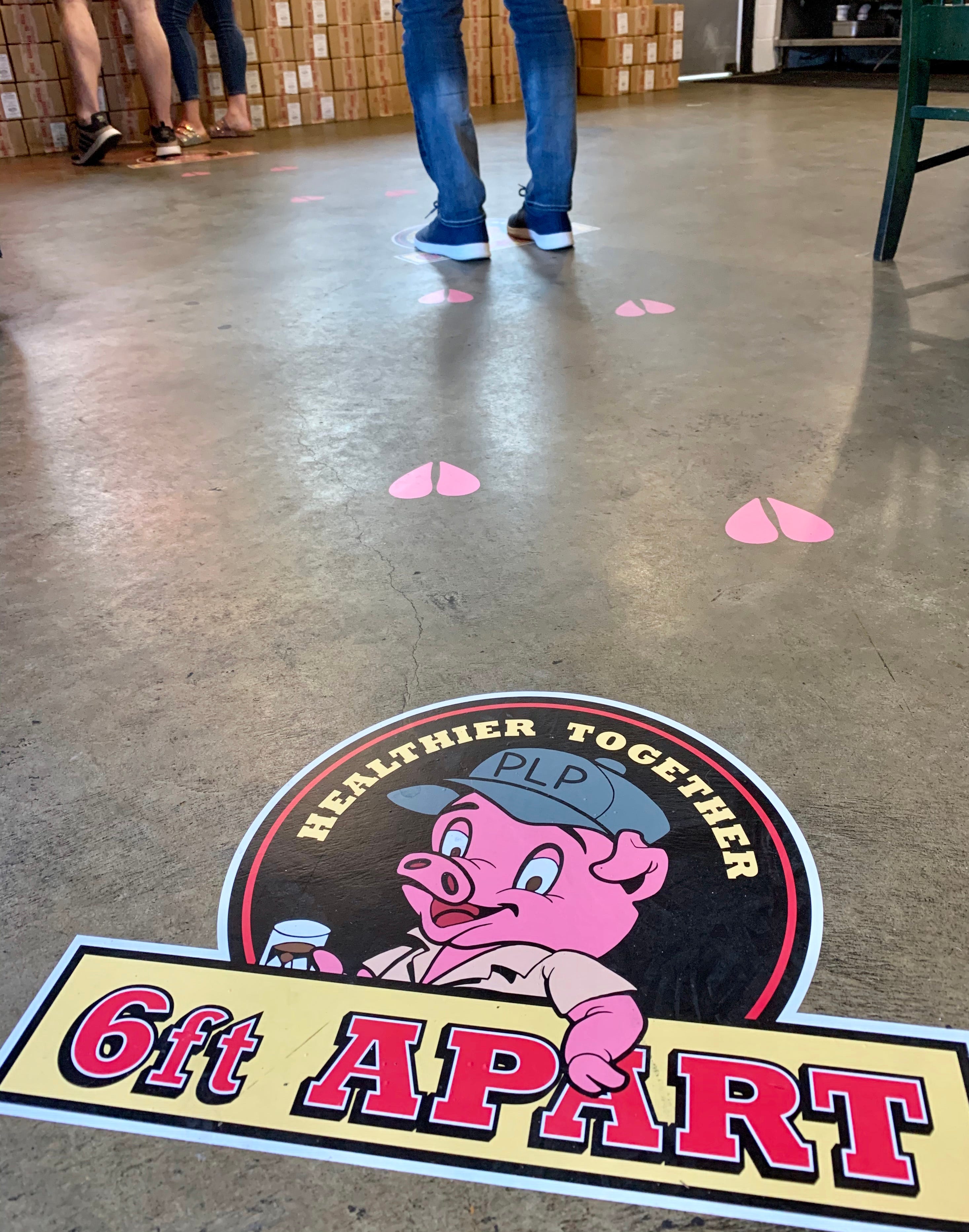 Social distancing guidelines are on the floor at Peg Leg Porker Monday, May 11, 2020, in Nashville, Tenn. Nonessential businesses have been closed for seven weeks due to the coronavirus pandemic.