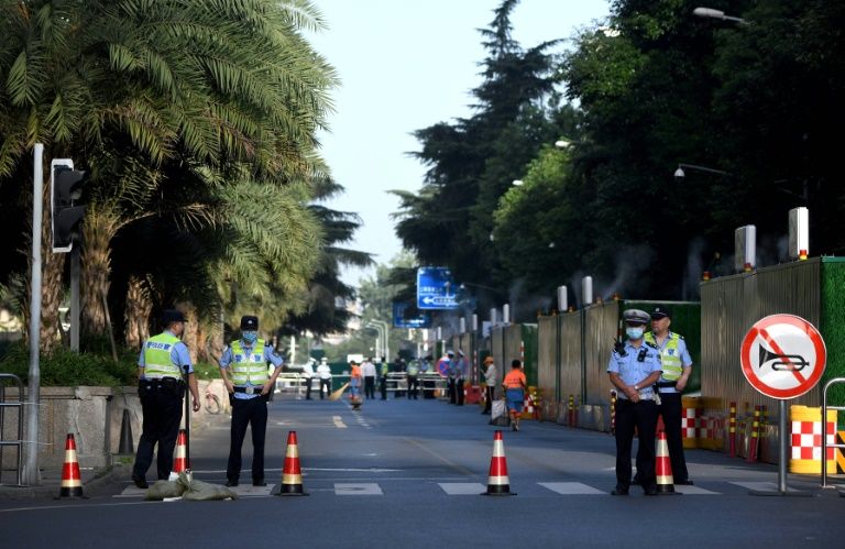 Police stand guard on a road leading to the US consulate in Chengdu, southwestern China's Sichuan province (AFP Photo/Noel Celis)
