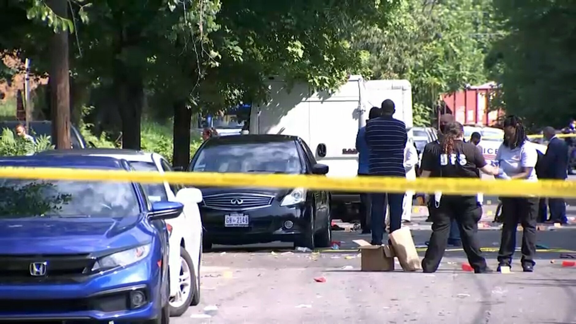 In this image from video provided by NBC4 Washington, law enforcement work the scene of a shooting, Sunday, Aug. 9, 2020, in Southeast Washington. (NBC4 Washington via AP)