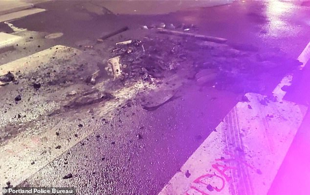 Police said they moved in to clear the crowd after a business was burgled and furniture dragged into the street where it was set on fire (remains of the fire above)