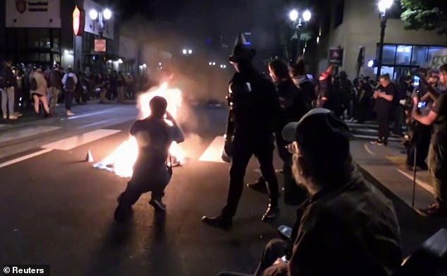 Protesters had started gathering in the north of Portland around 8pm before making their way to the mayor's apartment, where fires were lit shortly before 11pm