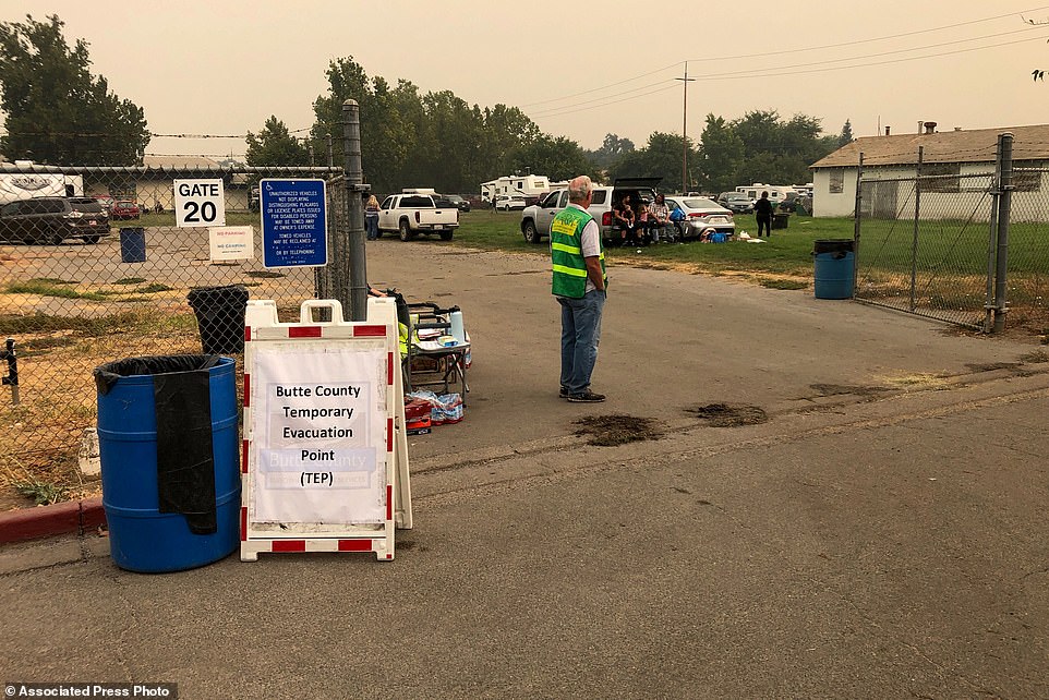 People fleeing from wildfires in Northern California gather at a temporary evacuation point in Gridley, California, on Thursday
