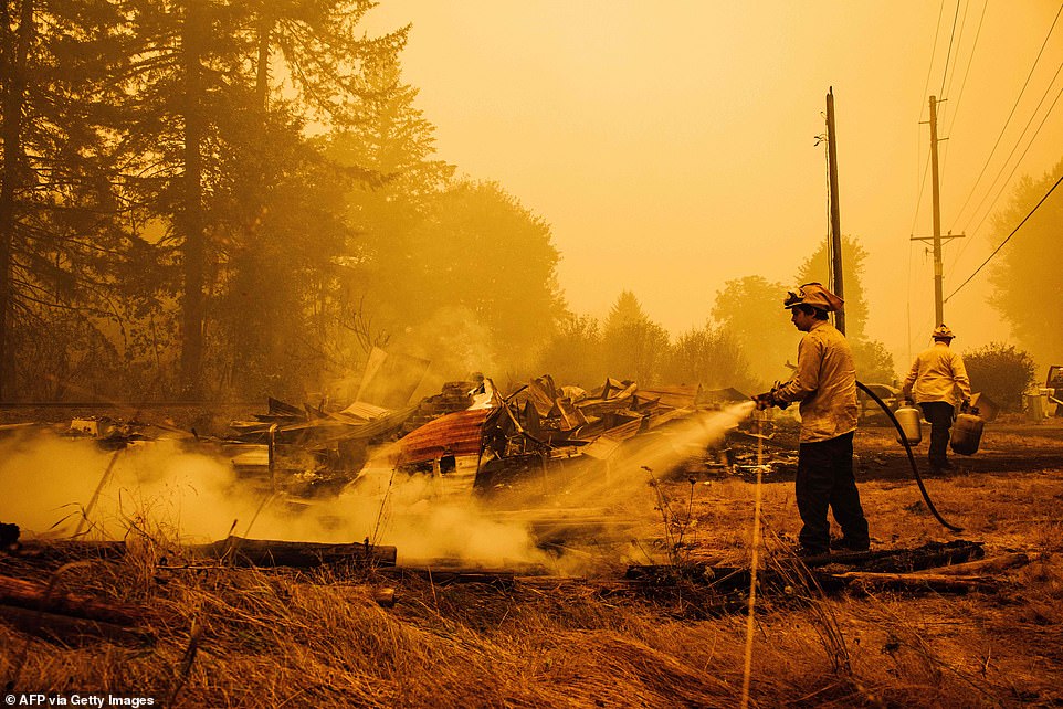 Oregon firefighters put out embers in Mill City, Oregon, on Thursday as they battle the Santiam Fire