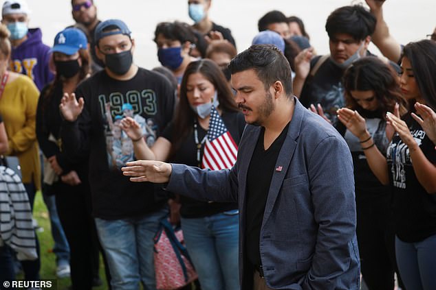 Chairman of the Republican National Hispanic Assembly of California Anthony Cabassa leads a vigil prayer following the ambush shooting