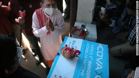 A priest performs prayer rituals on a carton containing the first consignment of Bharat Biotech's Covaxin vaccine.
