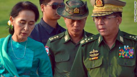 In this May 6, 2016, file photo, Aung San Suu Kyi, left, Myanmar's then foreign minister, walks with Senior Gen. Min Aung Hlaing, right, Myanmar military's commander in chief, in Naypyidaw.