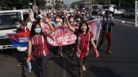 Protesters hold up the three finger salute during a demonstration against the military coup in Yangon on February 6, 2021.