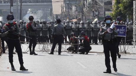 Riot police block a road in Yangon, Myanmar, 06 February 2021.