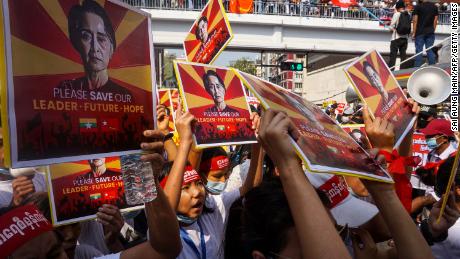 Protesters hold signs featuring Aung San Suu Kyi as they take part in a demonstration against the military coup in Yangon on February 22.