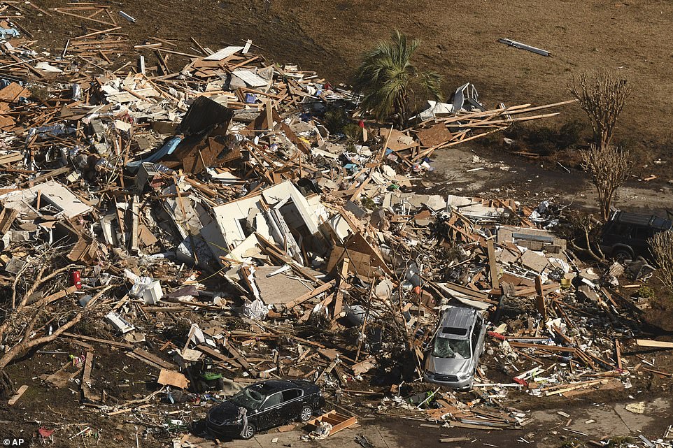 Cars were pictured with their windows and sun roofs broken and blown out after an EF-3 tornado ripped through North Carolina