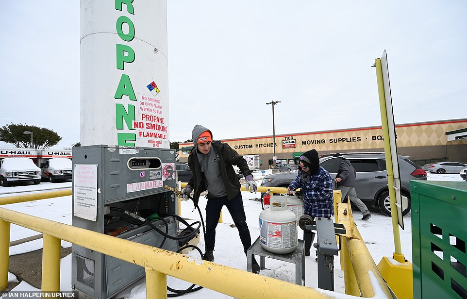 People wait to fill propane tanks outside of Dallas on Tuesday