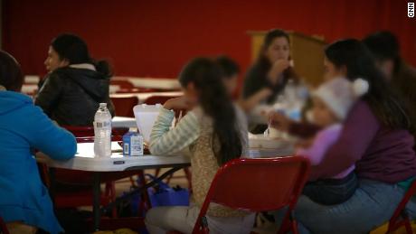 Newly arrived migrants get something to eat at the overflow shelter set up at Our Lady of Guadalupe in Mission, Texas
