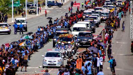 People line up as police escort a hearse carring the coffin of Papua New Guinea's first Prime Minister Michael Somare in Port Moresby on March 11.