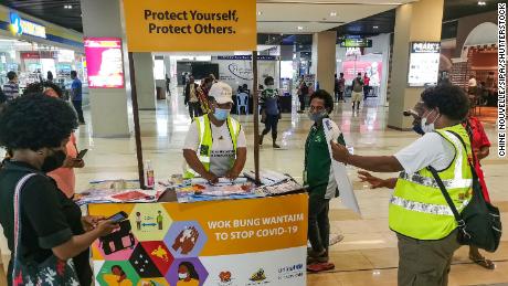 People learn how to prevent Covid-19 at a shopping center in the capital Port Moresby on September 4, 2020.