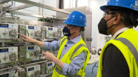 Mike McDermott, Pfizer's president of global supply, left, and CNN's Dr. Sanjay Gupta inside Pfizer's Kalamazoo, Michigan, manufacturing facility.