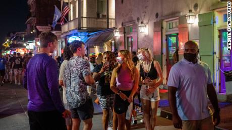 Emma Walton and Maddison Mansfield of Little Rock, Arkansas, walk down Bourbon Street in New Orleans.