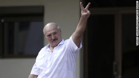 Lukashenko makes a victory sign for his supporters after the disputed 2020 election.