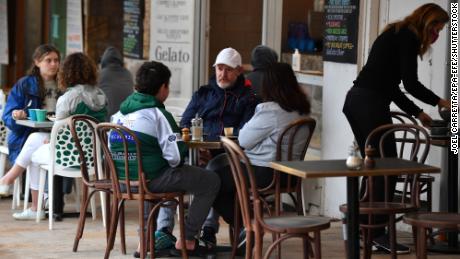 Diners sit at a cafe in Sydney, Australia on October 11 as the city emerges from lockdown.