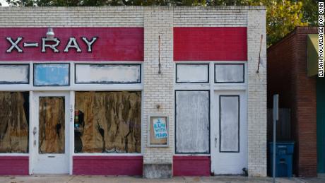 A handwritten "I Run With Maud" sign is seen on the facade of an unoccupied building in Brunswick.