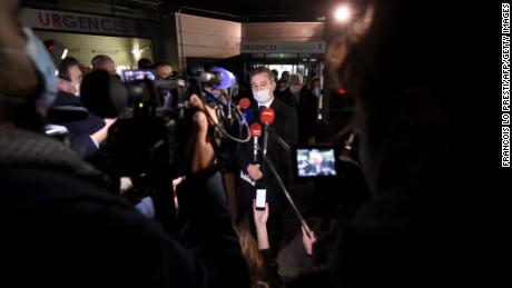 French Interior Minister Gerald Darmanin speaks to the press in front of a hospital in Calais, northern France, after at least 27 people died off the city's coast.