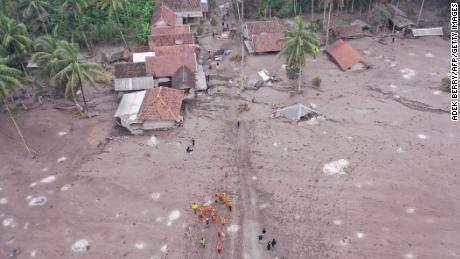 Members of a search and rescue team conduct a search operation for missing people at the Sumberwuluh village on December 6, 2021.
