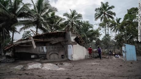 Villagers salvage what they can from their damaged homes at Sumber Wuluh village in Lumajang on December 6, 2021.