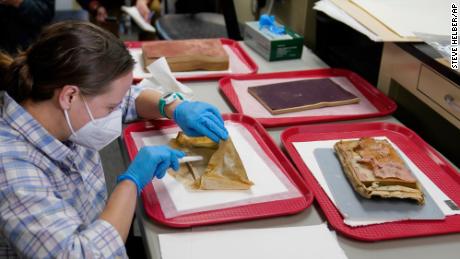 Sue Donovan, conservator for Special Collections at the University of Virginia, carefully looks at discovered items.