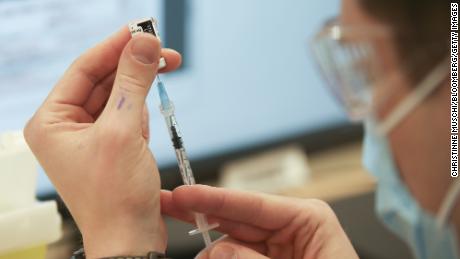 A health care worker in Montreal prepares a dose of the Pfizer/BioNTech Covid-19 vaccine in March 2021.