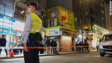 A police officer stands guard outside a pet store that was closed after some pet hamsters tested positive for Covid-19 in Hong Kong on January 18.