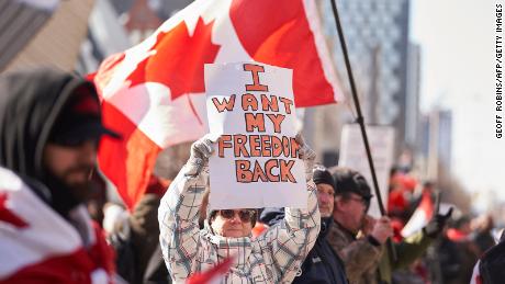 A demonstrator holds a sign during a protest against mandates related to Covid-19 vaccines and restrictions in downtown Toronto, Ontario, Canada, on February 5, 2022.