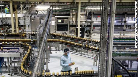 A worker checks a jar of Nestlé's instant coffee in the English city of Tutbury.