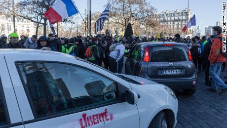Members of the "Freedom Convoy" are greeted by supporters upon their arrival to Paris' Place D'Italie on Saturday.