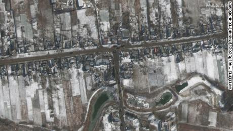 Russian military vehicles are seen sitting on roadways in residential areas in Ozera.