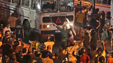 A Sri Lankan policeman tries to disperse protesters in Colombo, March 31, 2022.