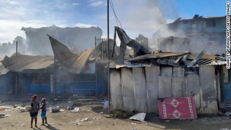 Smoke rises from burnt out buildings in Honiara's Chinatown on November 26, 2021 after two days of rioting.