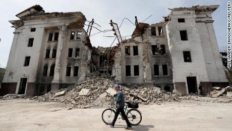 A man walks past the shell of Mariupol's Drama Theater on April 25.