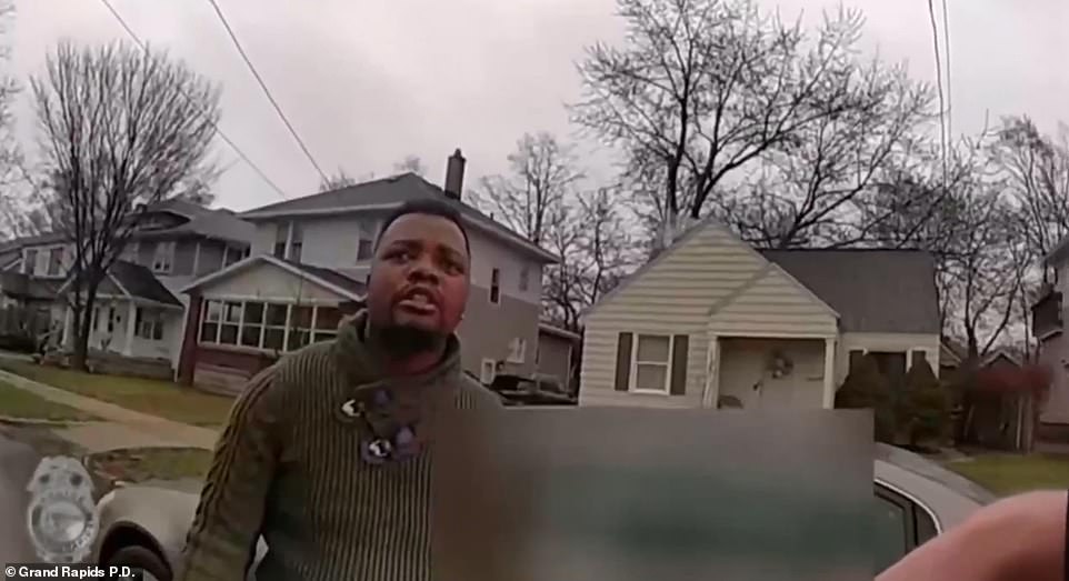 Lyoya appears to be complying, but then closes the driver-side door and attempts to walk away, resisting the officers attempts to handcuff him