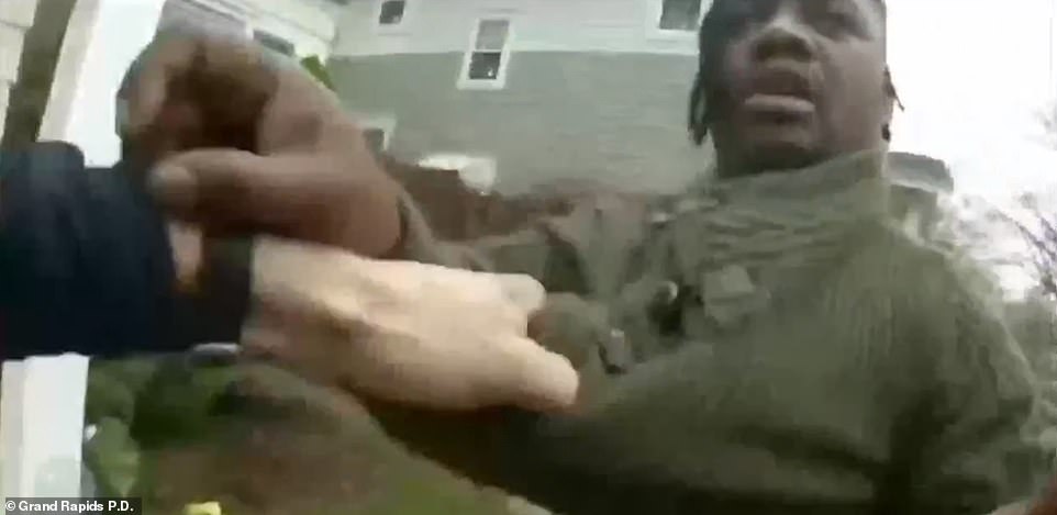 The white officer repeatedly orders Lyoya to 'let go' of his Taser, at one point demanding: 'Drop the Taser!'