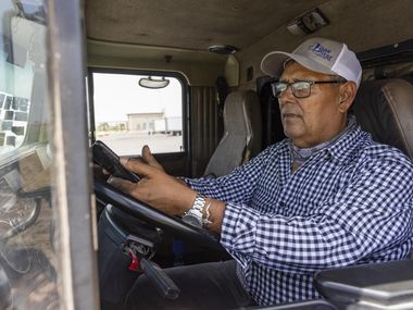 Alfredo García, an 18-wheeler driver transporting meat, waits on a side road as the...