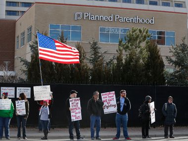 In this photo from Feb. 11, 2017, pro-choice counterprotesters held signs supporting a...