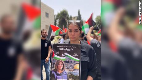 Shireen Abu Akleh's niece, Lareen, 19, at her aunt's funeral procession in Jerusalem. Her poster reads: "Shireen Abu Akleh, an icon of journalism and of free speech". Lareen is an aspiring journalist.