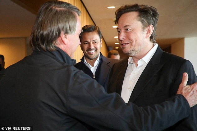 Bolsonaro is pictured greeting the South African-born billionaire ahead of their meeting at a hotel in the countryside outside of Sao Paulo